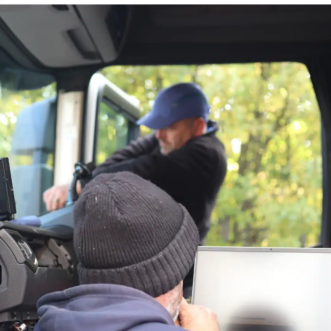Technicians installing in-cab camera system in a commercial vehicle