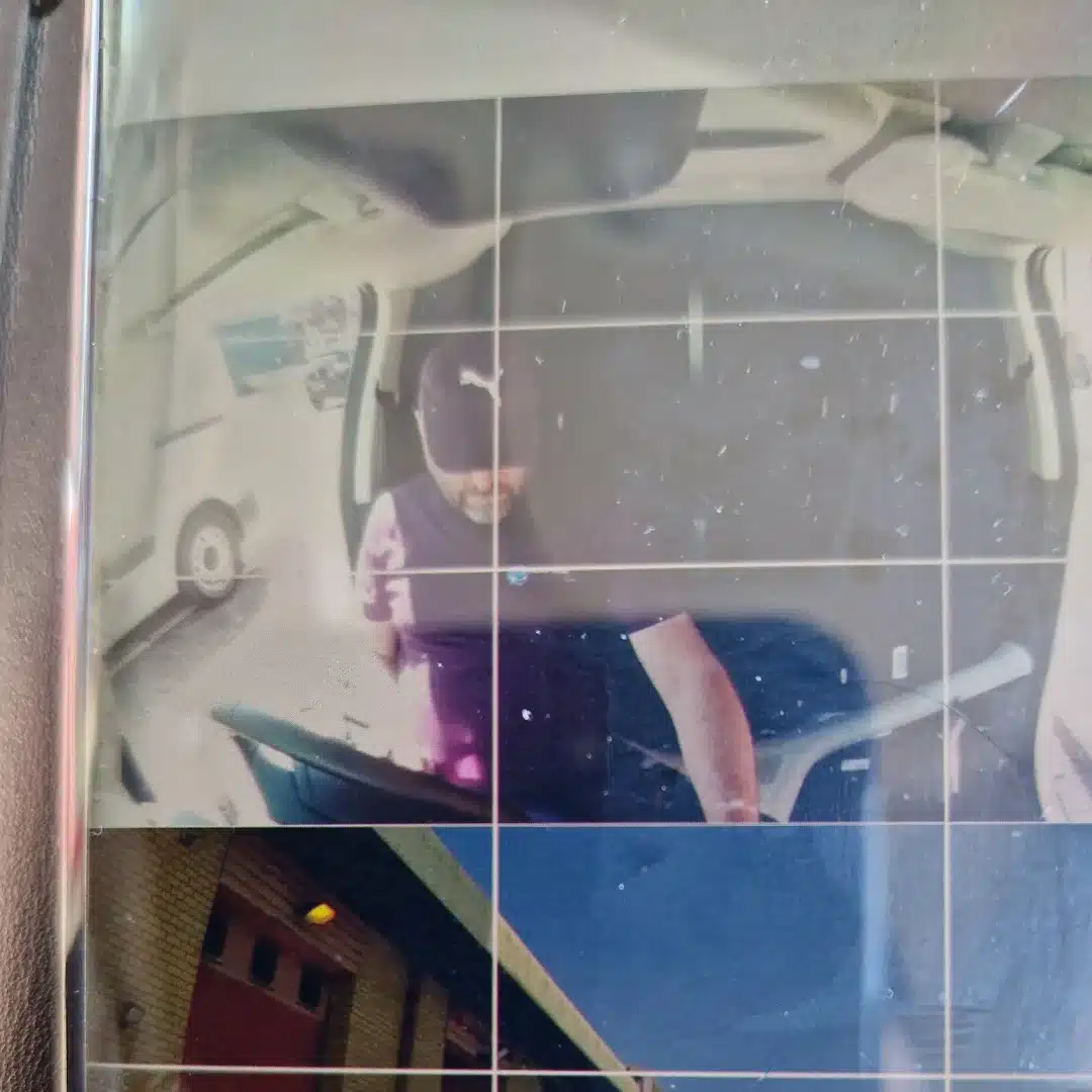 Camera footage showing a driver inside a commercial vehicle
