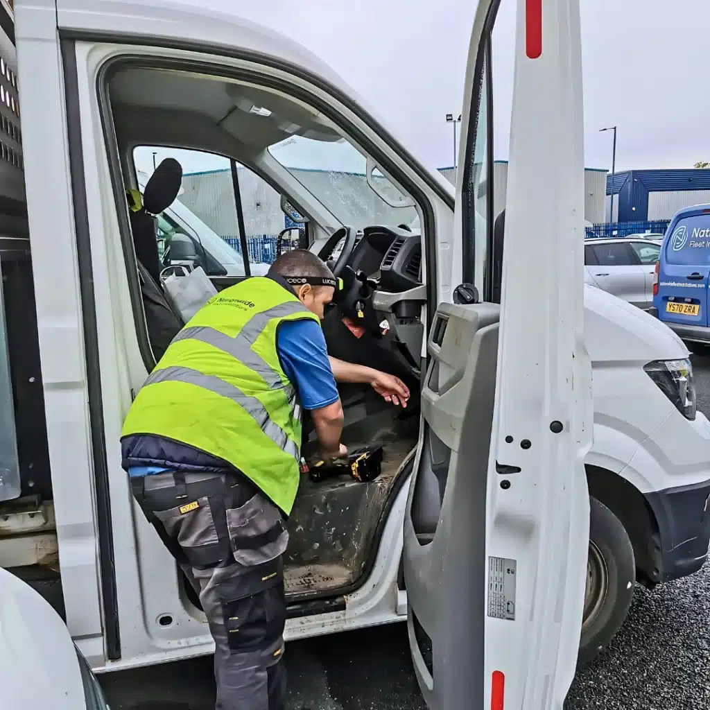 Technician installing telematics equipment inside a commercial van – Nationwide Fleet Installations