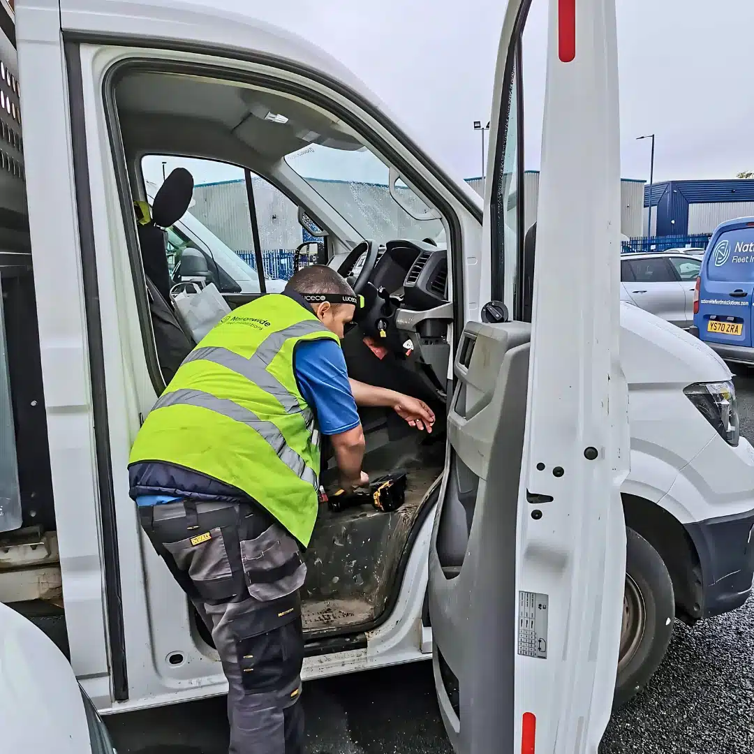 Technician installing telematics equipment inside a commercial van – Nationwide Fleet Installations