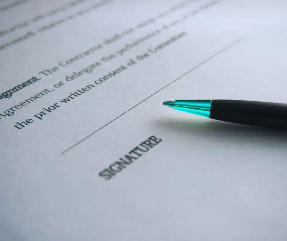 Signed contract agreement with pen on paper