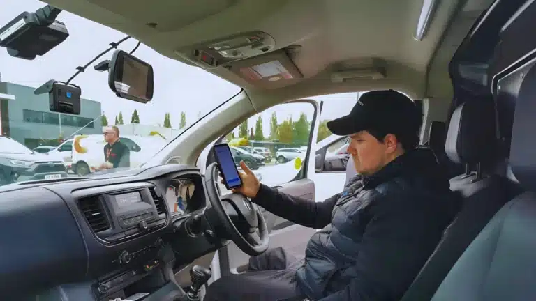 Engineer installing a driver-facing camera system in a commercial van in the UK.