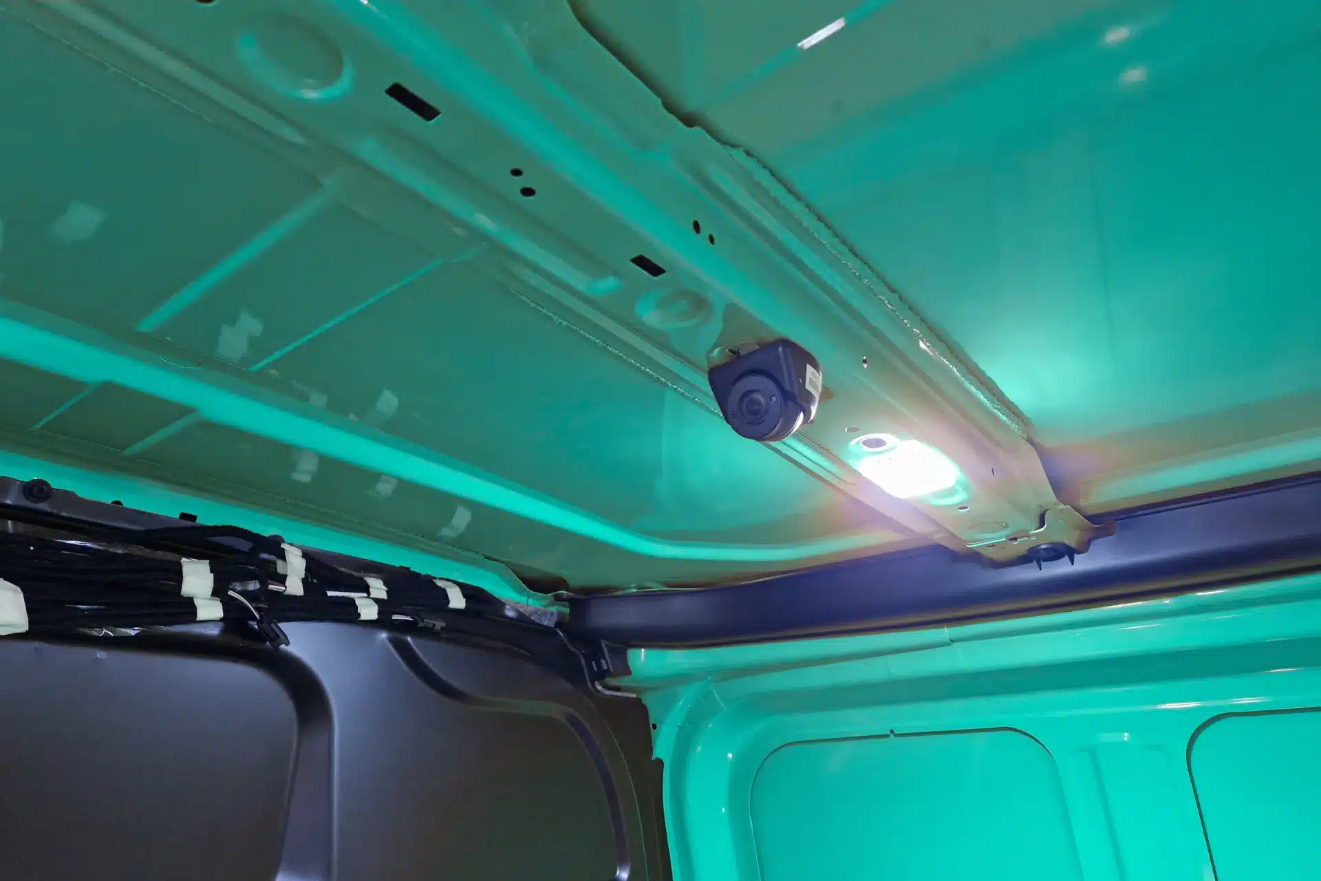 An internal CCTV camera is mounted inside the rear of a delivery van.