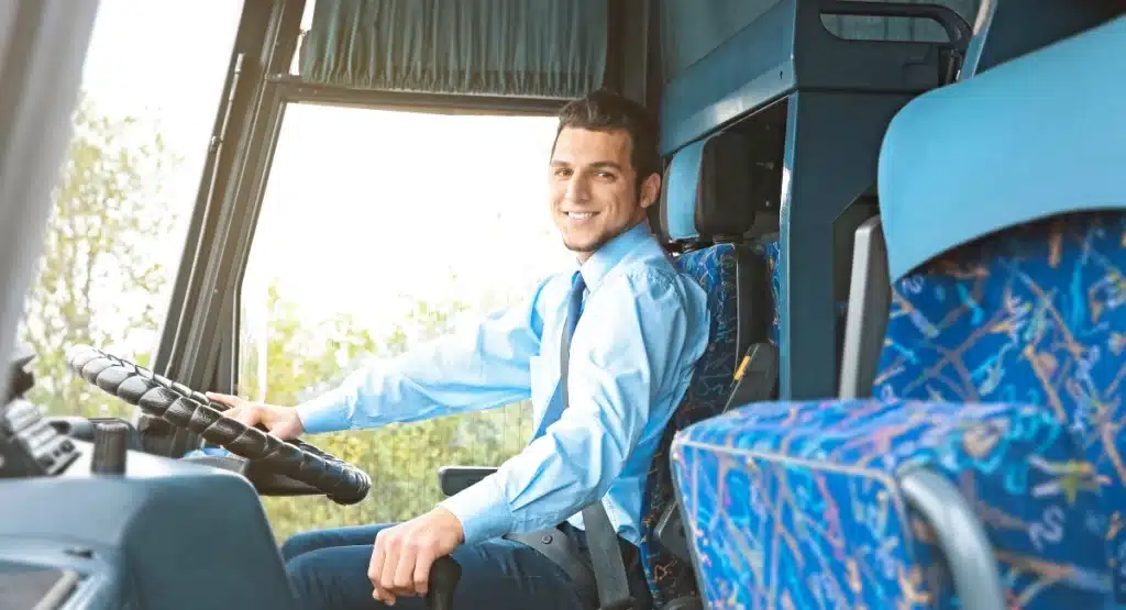 Professional driver smiling in a commercial vehicle fitted with a video telematics camera system