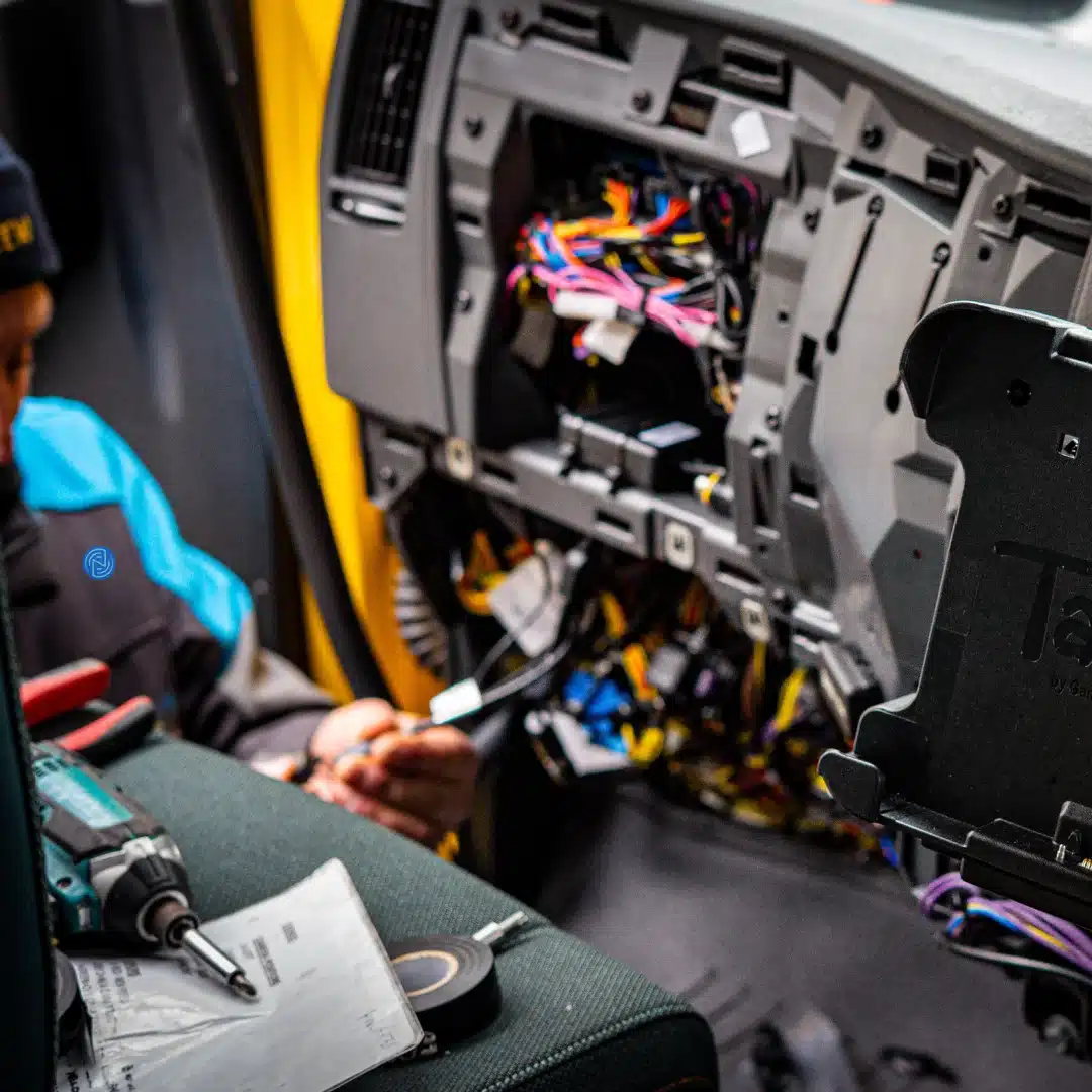 Vehicle interior with fitted tachograph and camera systems visible above the passenger seat