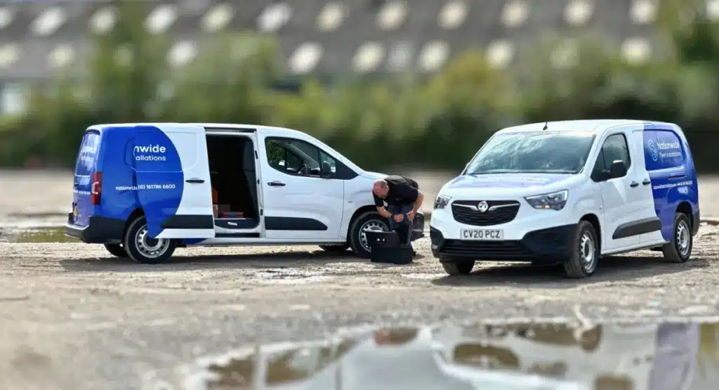 Installation engineer fitting a video telematics system to a fleet van in the field