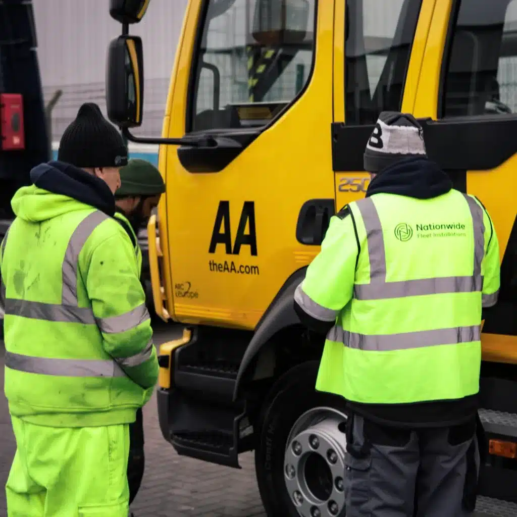 Nationwide Fleet Installations engineers working on a fleet vehicle in high-visibility clothing