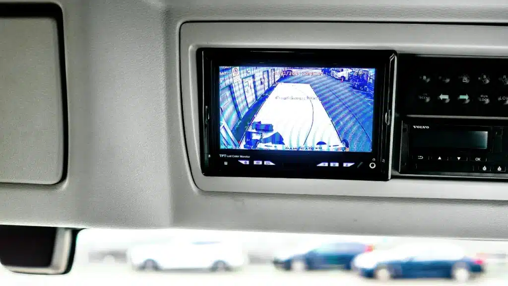 Rear-view camera and remote tacho downloads hardware installed in a commercial vehicle cab.