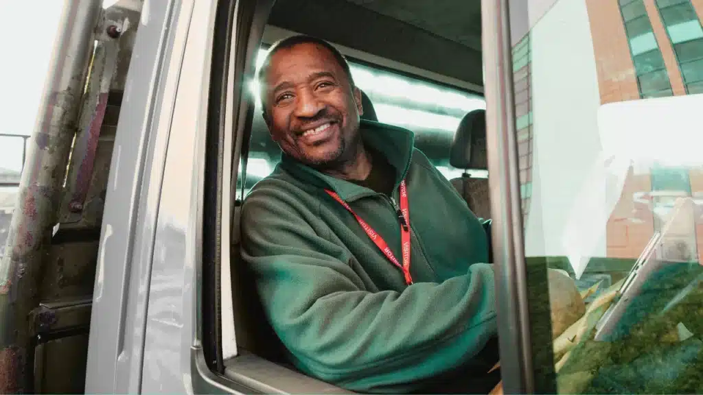 Smiling recovery truck driver seated in his vehicle