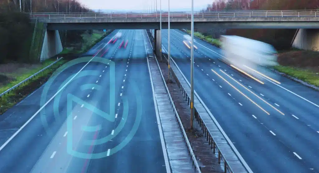 Fleet vehicle travelling on a motorway with telematics overlay, representing real-time tracking and video insights